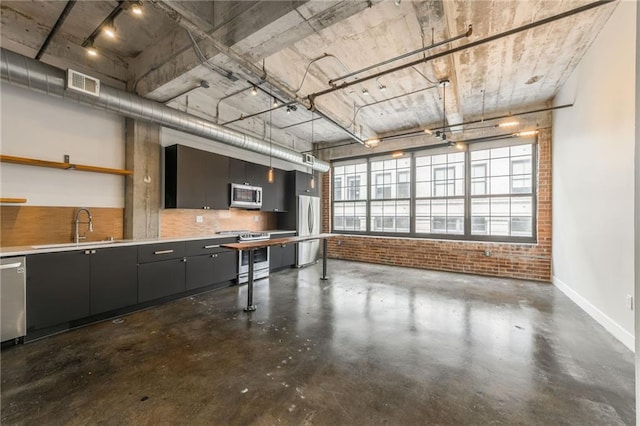 715 May St Unit 328, Kansas City, MO 64105 - garage featuring a sink and freestanding refrigerator