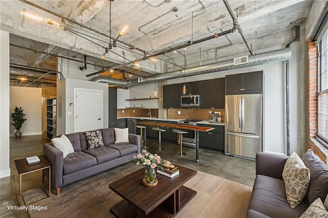 715 May St Unit 328, Kansas City, MO 64105 - living area with baseboards and concrete floors