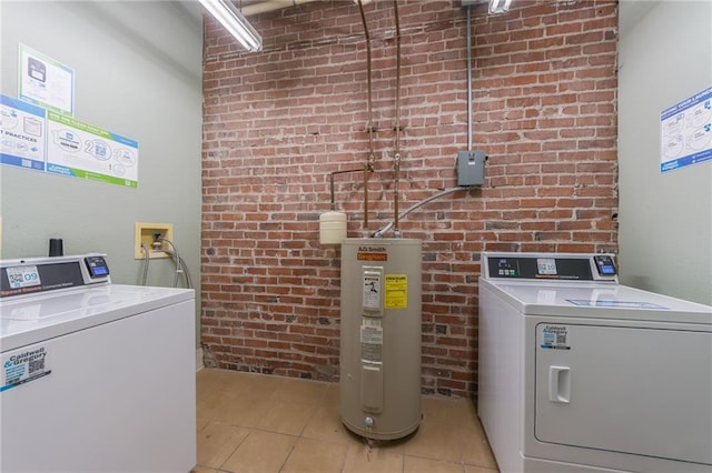 715 May St Unit 328, Kansas City, MO 64105 - laundry room featuring electric water heater, separate washer and dryer, brick wall, and light tile patterned floors