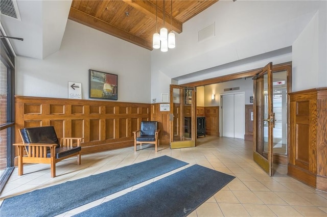 715 May St Unit 328, Kansas City, MO 64105 - building lobby with a wood ceiling with exposed beams, high vaulted ceiling, and a wainscoted wall