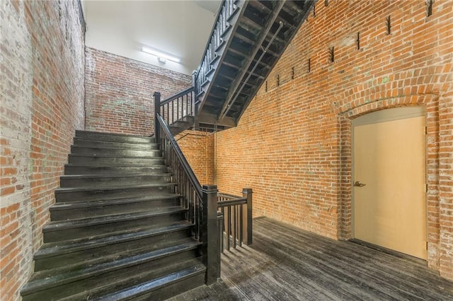 715 May St Unit 328, Kansas City, MO 64105 - stairs featuring a towering ceiling, brick wall, and wood finished floors