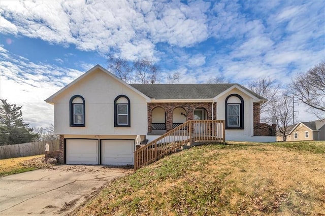 view of front of property featuring a garage, concrete driveway, fence, a porch, and a front yard