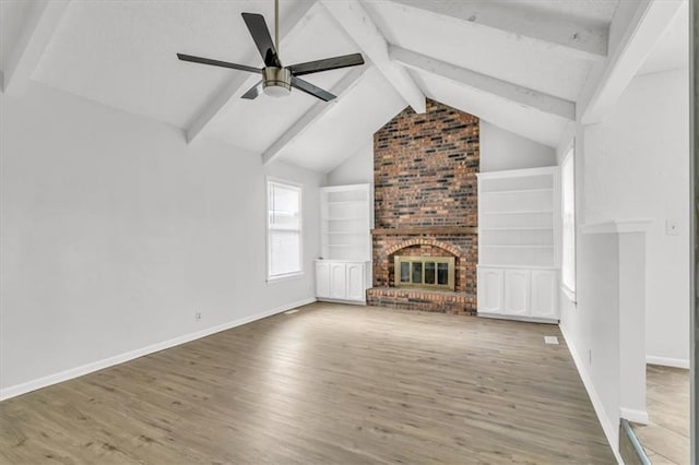 unfurnished living room with a fireplace, wood finished floors, and baseboards