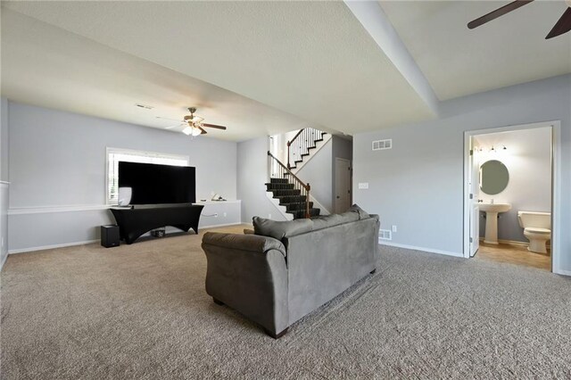 12304 White Oak St, Peculiar, MO 64078 - carpeted living area with stairway, baseboards, visible vents, and ceiling fan