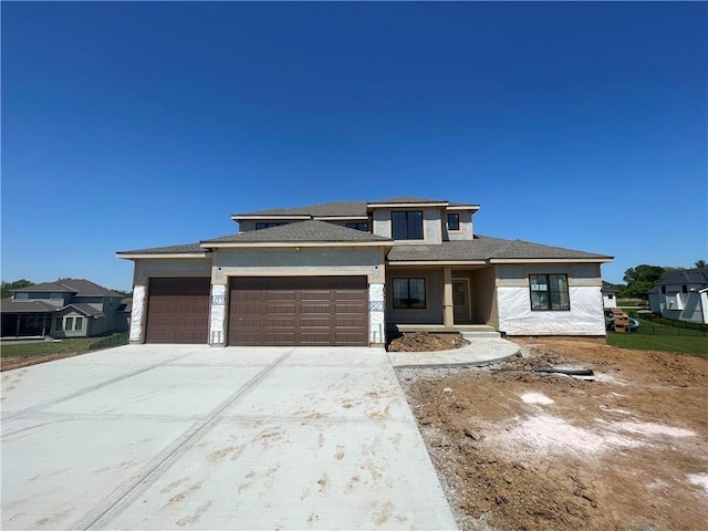 1820 Arbor Trl, Liberty, MO 64068 - prairie-style house featuring a garage, concrete driveway, stucco siding, and a porch