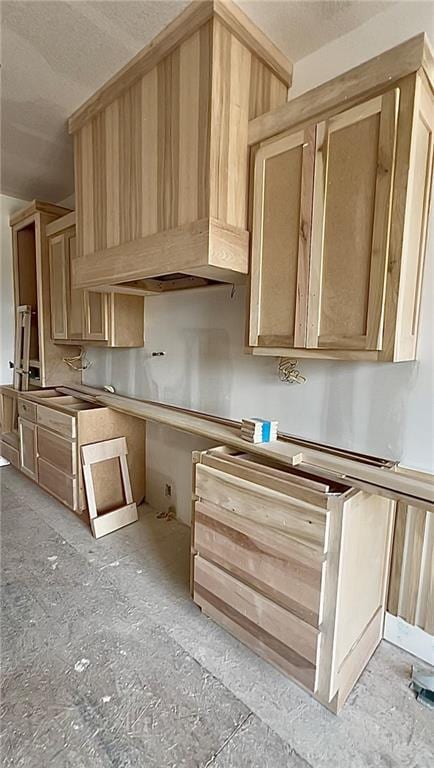 20840 Golden Rd, Linwood, KS 66052 - kitchen with a textured ceiling, light brown cabinets, a sink, and custom range hood