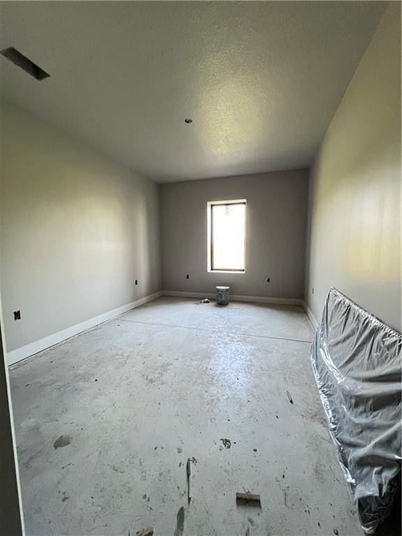 20840 Golden Rd, Linwood, KS 66052 - empty room featuring concrete floors and baseboards