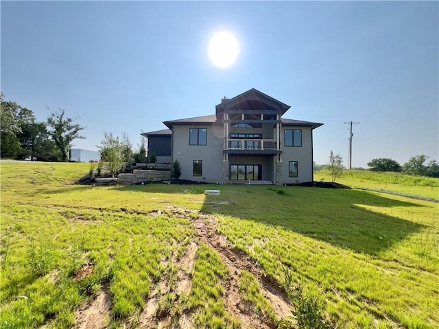 20840 Golden Rd, Linwood, KS 66052 - back of property featuring a lawn, stucco siding, and a balcony