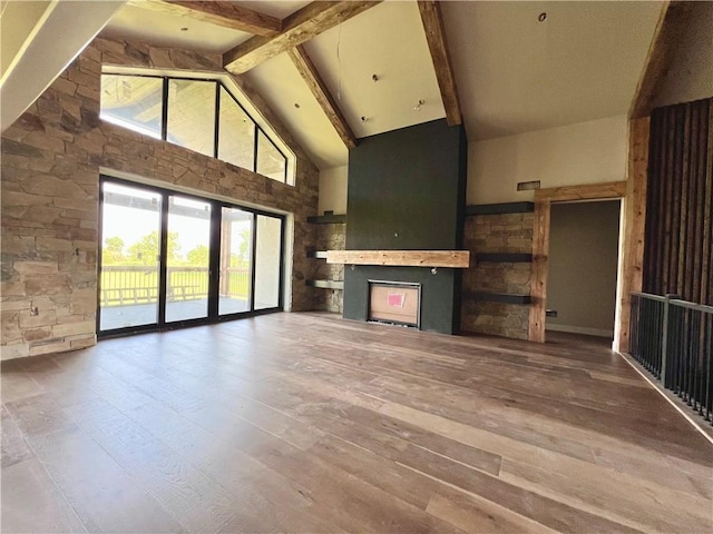 20840 Golden Rd, Linwood, KS 66052 - unfurnished living room featuring high vaulted ceiling, beamed ceiling, and hardwood / wood-style floors