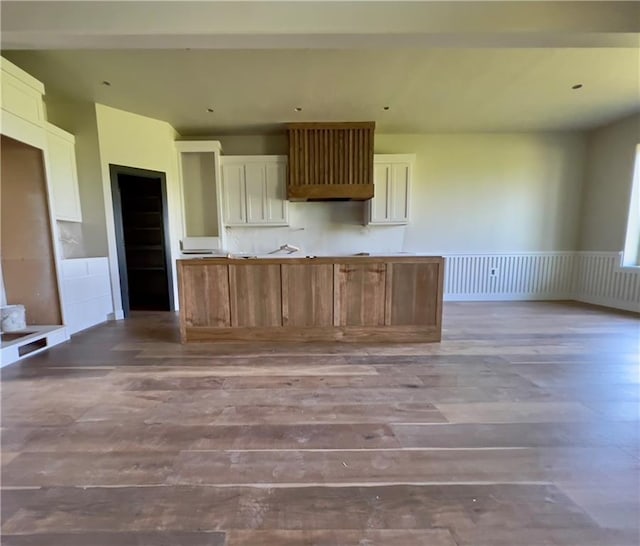 20840 Golden Rd, Linwood, KS 66052 - kitchen featuring wood finished floors, wainscoting, white cabinets, and a kitchen island
