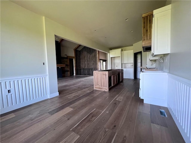 20840 Golden Rd, Linwood, KS 66052 - kitchen with white cabinets, dark wood-style flooring, wainscoting, a center island, and open floor plan