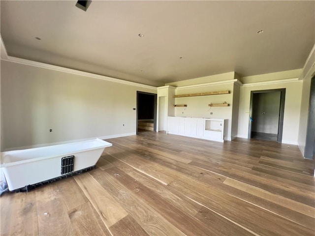 20840 Golden Rd, Linwood, KS 66052 - unfurnished living room featuring hardwood / wood-style floors and ornamental molding