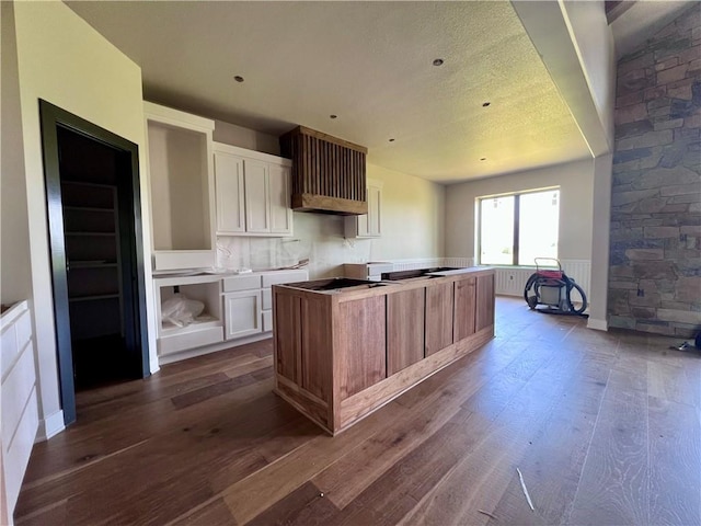 20840 Golden Rd, Linwood, KS 66052 - kitchen featuring dark wood-style flooring, a center island, white cabinetry, and a textured ceiling