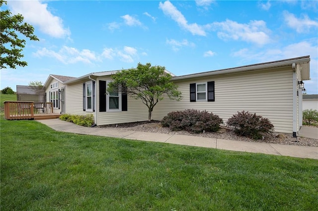 exterior space featuring a wooden deck and a front lawn