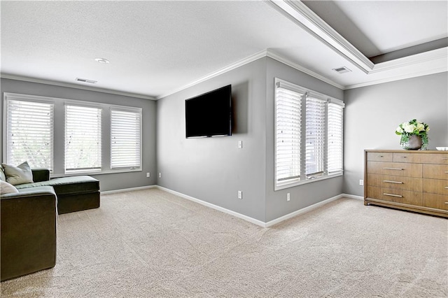 living area featuring visible vents, ornamental molding, carpet flooring, and a wealth of natural light