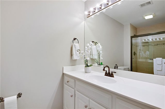 bathroom featuring visible vents, a shower stall, and vanity