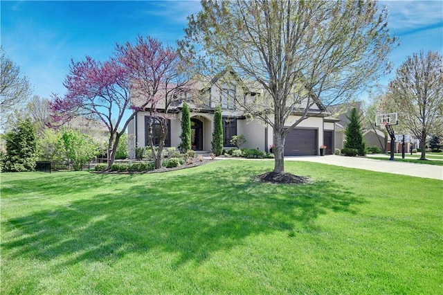 view of front of home with a garage, a front lawn, and driveway