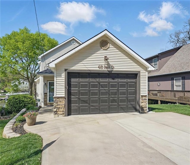 62 Beach Dr, Lake Tapawingo, MO 64015 - view of front of property featuring stone siding, an attached garage, and driveway