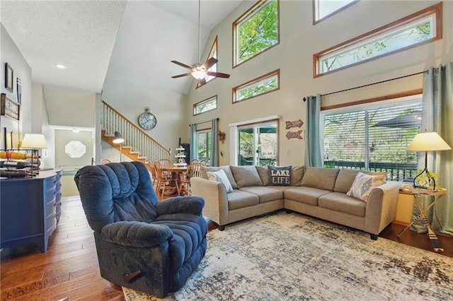62 Beach Dr, Lake Tapawingo, MO 64015 - living room with stairway, hardwood / wood-style floors, ceiling fan, a high ceiling, and recessed lighting