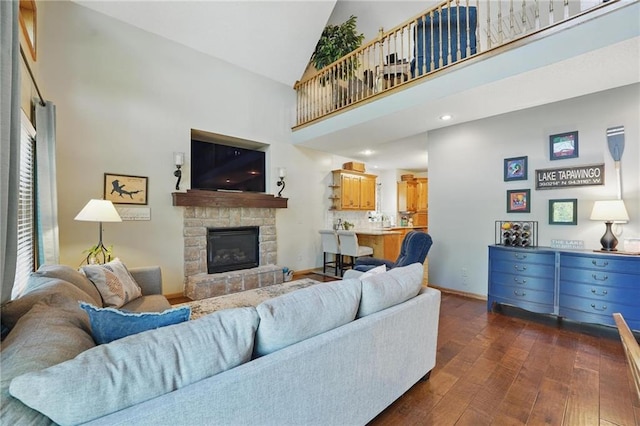 62 Beach Dr, Lake Tapawingo, MO 64015 - living room featuring dark wood-style flooring, high vaulted ceiling, a stone fireplace, and baseboards