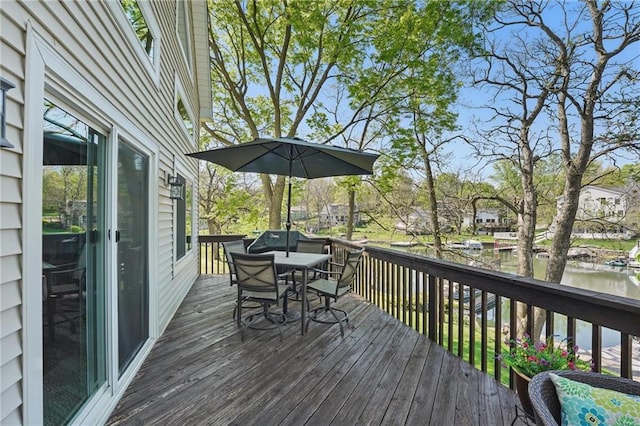 62 Beach Dr, Lake Tapawingo, MO 64015 - wooden deck with outdoor dining area and a water view