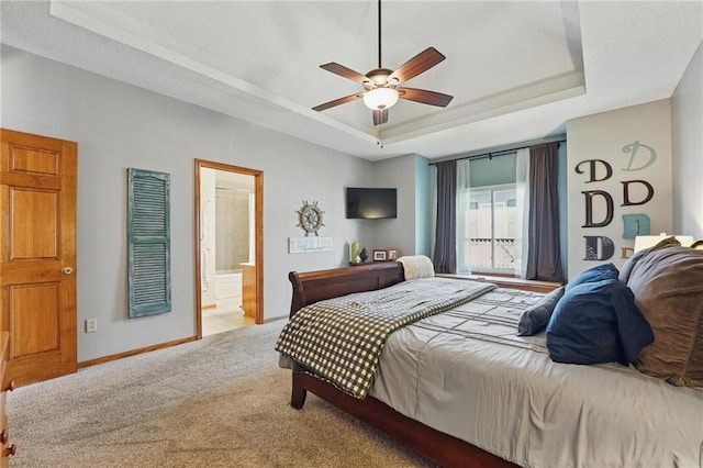 62 Beach Dr, Lake Tapawingo, MO 64015 - bedroom with a tray ceiling, baseboards, carpet floors, connected bathroom, and a ceiling fan