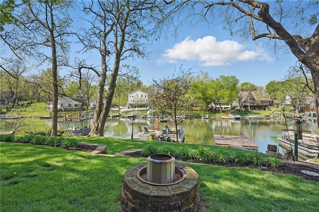 62 Beach Dr, Lake Tapawingo, MO 64015 - surrounding community with a boat dock, a water view, a yard, and an outdoor fire pit