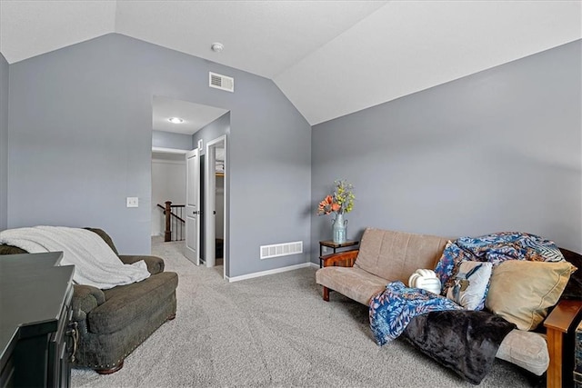 carpeted living room with baseboards, visible vents, and vaulted ceiling