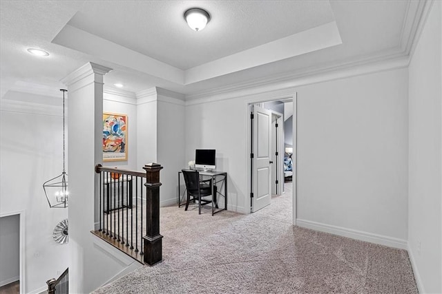 carpeted home office with baseboards, a textured ceiling, a raised ceiling, and ornamental molding