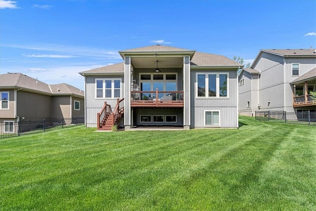 rear view of property with stairs, a fenced backyard, a yard, and a shingled roof