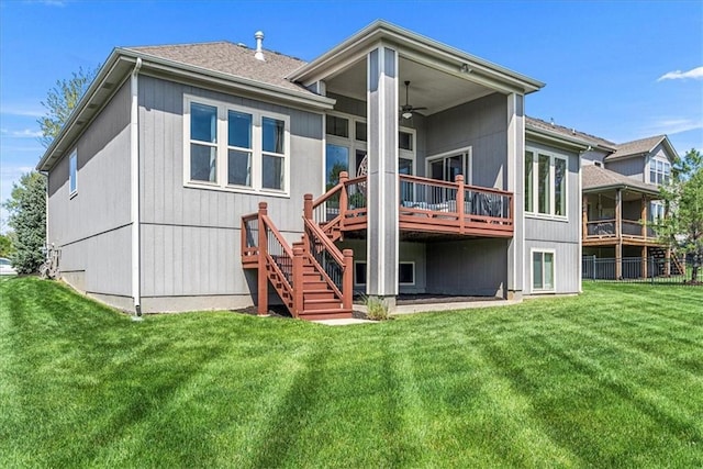 back of property with a lawn, stairway, a ceiling fan, and a wooden deck