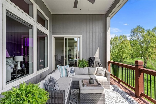 wooden terrace featuring ceiling fan and an outdoor living space