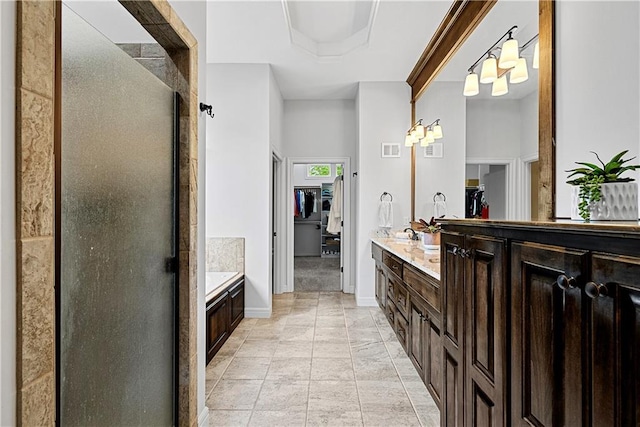 full bathroom featuring vanity, visible vents, a shower stall, and a spacious closet