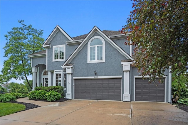 14215 W 157th Ter, Olathe, KS 66062 - traditional-style home featuring stucco siding, driveway, and an attached garage