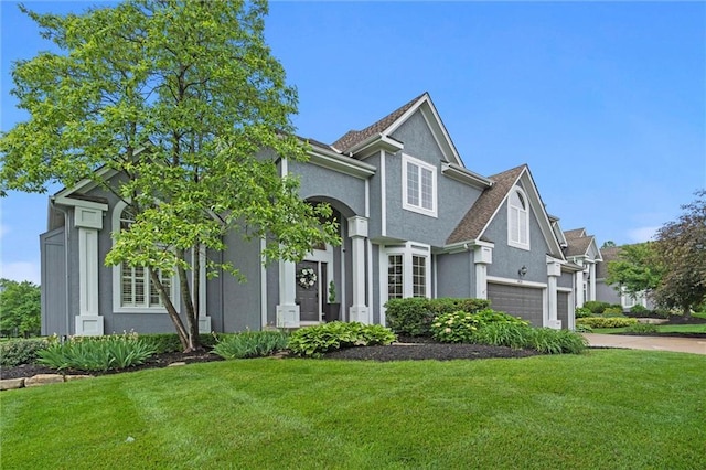 14215 W 157th Ter, Olathe, KS 66062 - view of front facade featuring a front lawn, stucco siding, and driveway