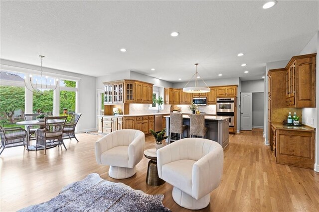 14215 W 157th Ter, Olathe, KS 66062 - living area with light wood-style floors, baseboards, recessed lighting, and a chandelier