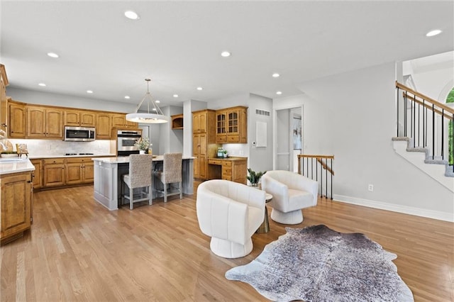 14215 W 157th Ter, Olathe, KS 66062 - living area with light wood-style flooring, recessed lighting, baseboards, and stairs