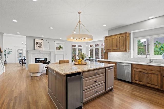 14215 W 157th Ter, Olathe, KS 66062 - kitchen featuring dishwasher, a sink, a kitchen island, wood finished floors, and backsplash