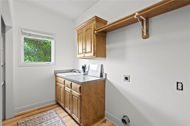 14215 W 157th Ter, Olathe, KS 66062 - laundry room featuring hookup for an electric dryer, light wood-style floors, and baseboards