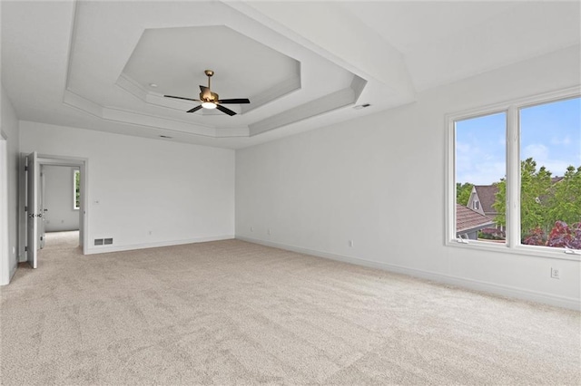 14215 W 157th Ter, Olathe, KS 66062 - unfurnished room with healthy amount of natural light, a raised ceiling, light colored carpet, and a ceiling fan