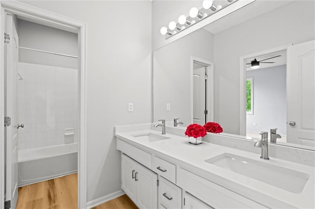 14215 W 157th Ter, Olathe, KS 66062 - bathroom featuring double vanity, wood finished floors, and tub / shower combination