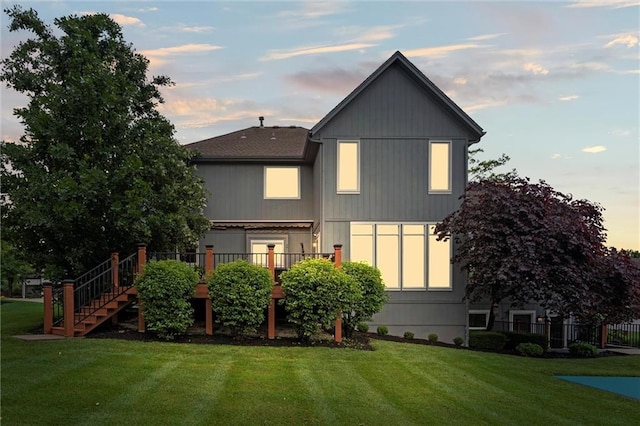 14215 W 157th Ter, Olathe, KS 66062 - rear view of house featuring a lawn, stairway, and a deck