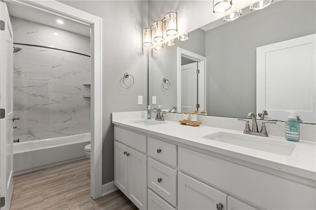 17894 169th St, Basehor, KS 66007 - full bathroom featuring double vanity, washtub / shower combination, and wood finished floors