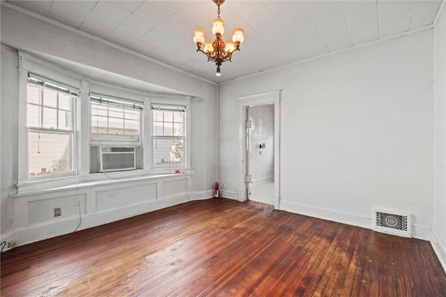 unfurnished dining area with wood-type flooring, a chandelier, visible vents, and cooling unit