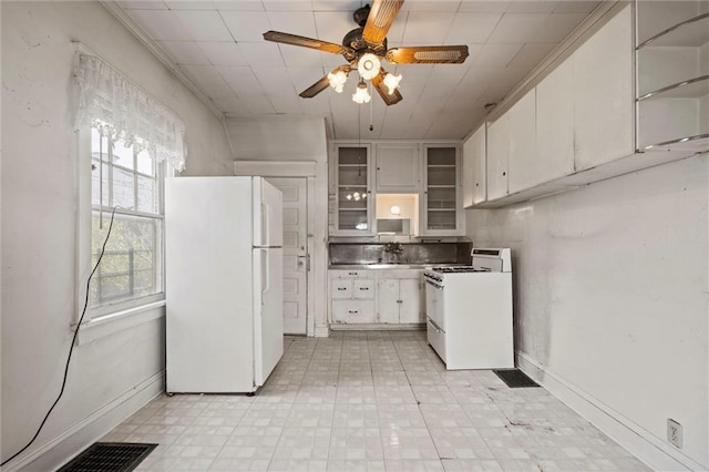 kitchen with glass insert cabinets, light floors, ceiling fan, and white appliances