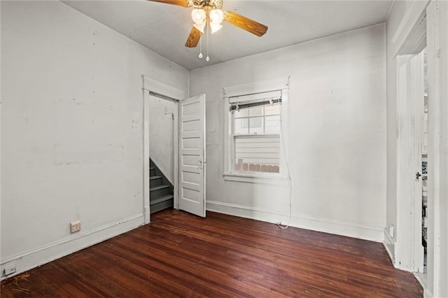 unfurnished bedroom featuring a ceiling fan, baseboards, and wood finished floors