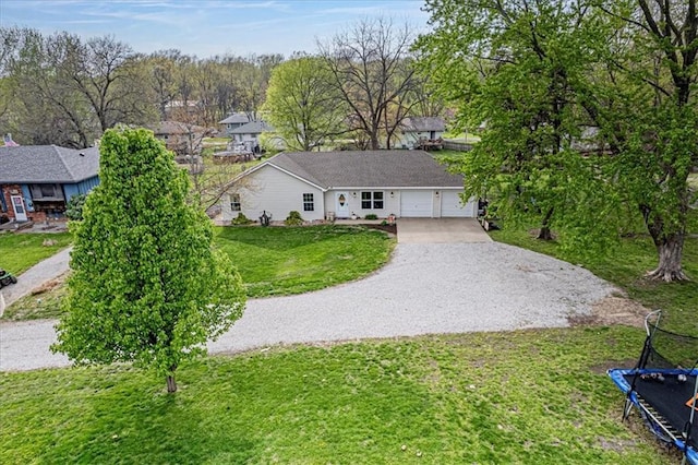 204 Lynn St, Lathrop, MO 64465 - view of front of house with driveway, a front lawn, and a garage