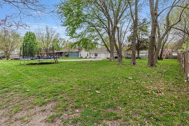 204 Lynn St, Lathrop, MO 64465 - view of yard with a trampoline and an attached garage