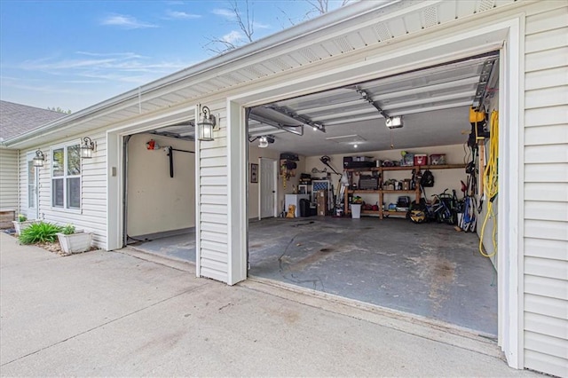 204 Lynn St, Lathrop, MO 64465 - garage with a garage door opener and concrete driveway