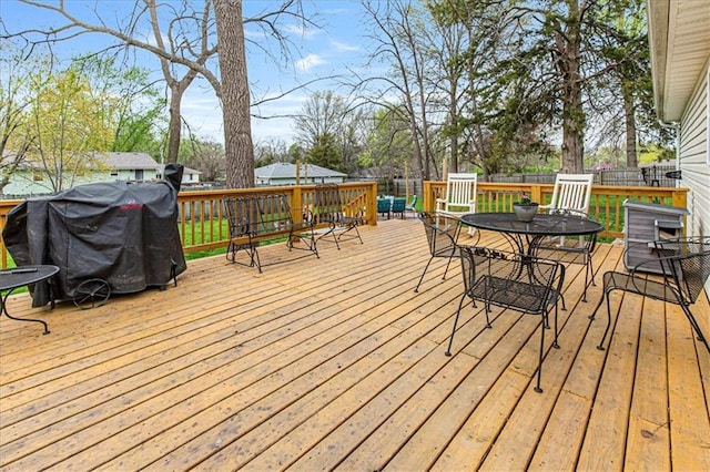 204 Lynn St, Lathrop, MO 64465 - wooden deck with outdoor dining space and a grill